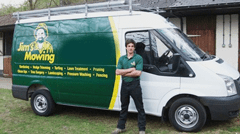 Man in front of Jim's Mowing van